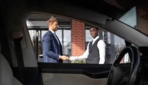 Chauffeur receiving payment from an executive client, highlighting ZechionRide’s professional and premium corporate transportation services in NYC.