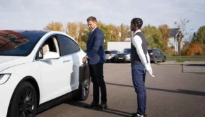 Chauffeur waiting for an executive beside a luxury vehicle, highlighting ZechionRide’s professional corporate transportation services in NYC.
