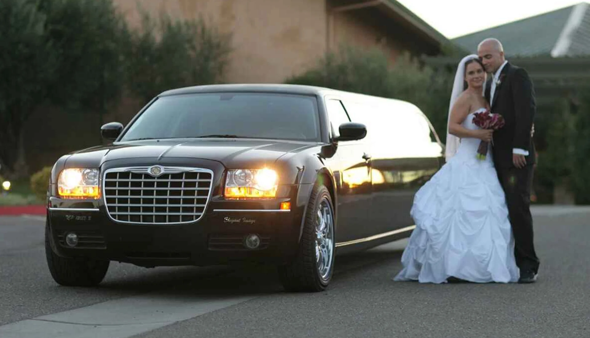 Top Reasons to Choose Car Rental NYC Over Ride-Sharing Services 1 Newlywed couple standing with a luxury limousine, showcasing ZechionRide’s wedding limo services in NYC.