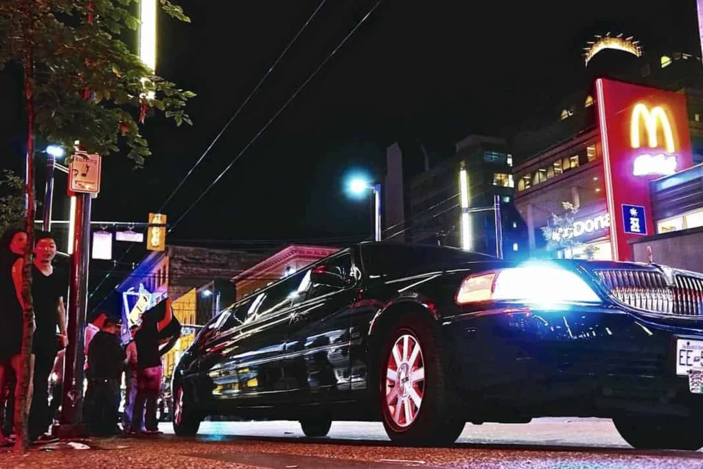 Limousine parked on the roadside at night, highlighting its role in nightlife transportation