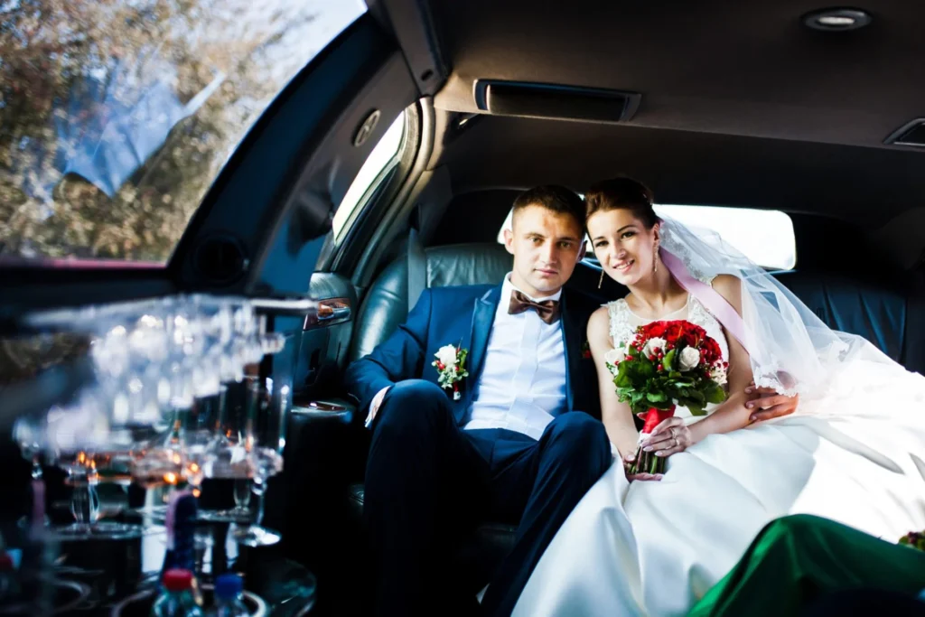 Newlyweds relax in the back of a limo, enjoying their wedding day ride together