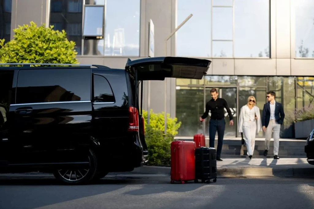 People walking toward a black van, which is designated for hotel limo transfers