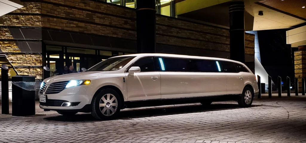 White limousine parked in front of a hotel