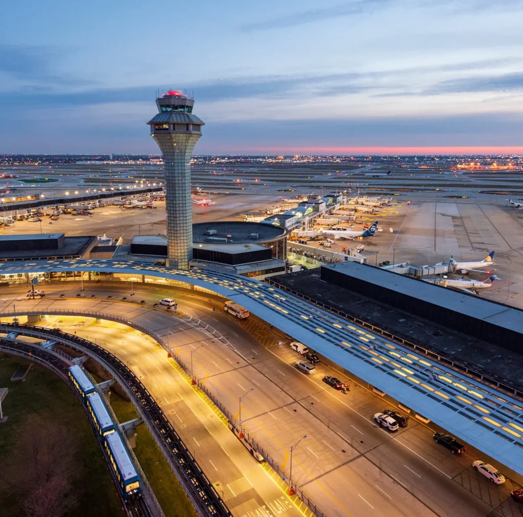 A Chicago airport featuring a large control tower and a runway, highlighting major transportation hubs in the city