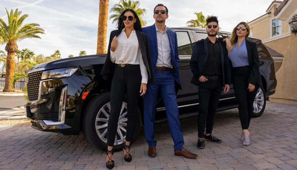 People dressed in business attire stand next to a black SUV highlighting Family Magics luxury transportation in Orlando