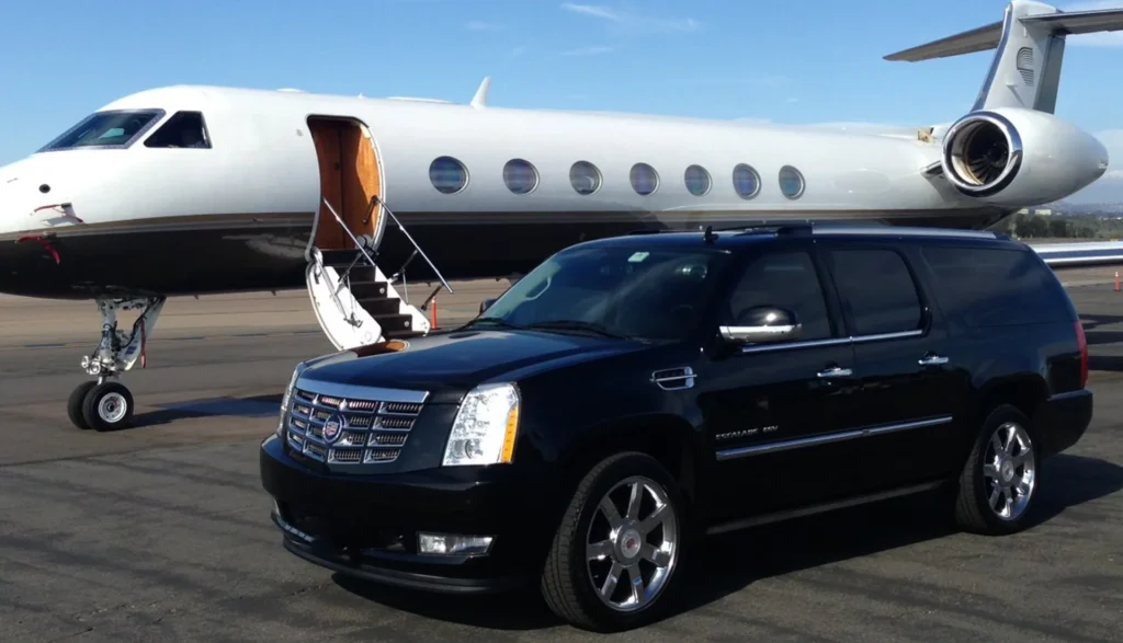 Choosing a Luxury Limousine for Your Airport Limo Service in Los Angeles 2 Sleek black Cadillac SUV next to a private jet, highlighting premium transportation choices at LAX in Los Angeles